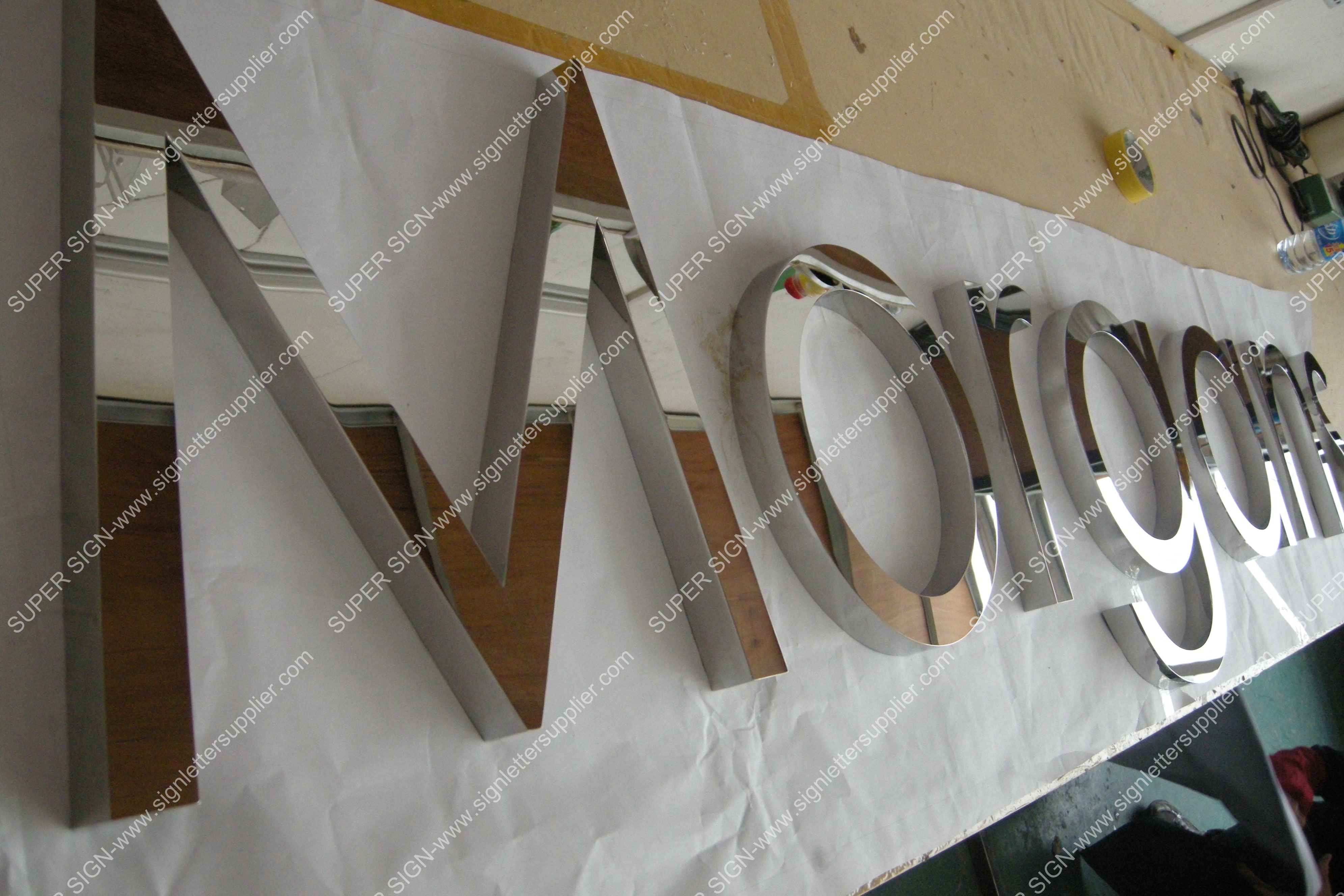 Fabricated polished steel letter